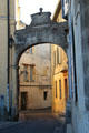 Arch across narrow street near Antique Theater of Arles. Arles, France.