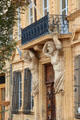 Sculpted figures hold up balcony in narrow streets of old Aix. Aix-en-Provence, France.