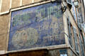Antique commercial sign on wall of old town building. Aix-en-Provence, France.