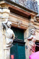 Door surround with sculpted figures near town hall. Aix-en-Provence, France.