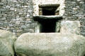 Newgrange passage tomb entrance with carved prehistoric rock swirls,. Ireland.