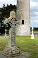 A typical Irish high cross & O'Rourke's Tower at Clonmacnoise. Ireland.