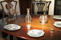 18th C tableware on Irish mahogany table at National Museum Decorative Arts & History. Dublin, Ireland.