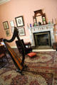 Living room with harp in front of fireplace at Pearse Museum. Dublin, Ireland.
