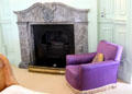 Bedroom fireplace with purple armchair at Russborough House. Ireland.