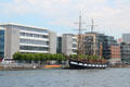 Jeanie Johnstone Tall Ship before modern buildings on River Liffey. Dublin, Ireland.