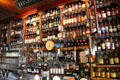 Liquor bottles crowded on shelves at Dick Mack's Pub in Dingle. Dingle, Ireland.