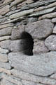 Only window opening, wider on interior than exterior, of Gallarus Oratory on Dingle Peninsula. Ireland.