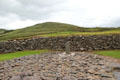 Ancient stone with cross at Gallarus Oratory on Dingle Peninsula. Ireland.