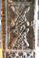 Lace with eight human heads detail on Cross of Scriptures at Clonmacnoise museum. Ireland.