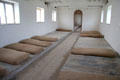 Residents' sleeping quarters with rough mattresses on floor shelf at Irish Workhouse Centre. Portumna, Ireland