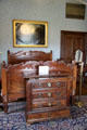 Blue bedroom with chest of drawers & carved bed at Kilkenny Castle. Ireland.