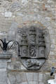 Carved coat of arms with archers atop castle on Kilkenny city hall. Kilkenny, Ireland.