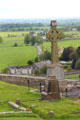 Celtic cross over town & country at Rock of Cashel. Cashel, Ireland.