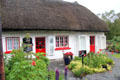 Thatched roof & red trimmed cottage. Adare, Ireland