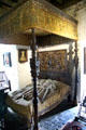 Carved wooden bedstead with tapestry canopy in Earl's bedroom at Bunratty Castle. County Clare, Ireland.