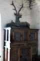 Ornately carved cupboard topped by statue of a stag in Earl's private apartments at Bunratty Castle. County Clare, Ireland.