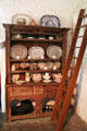 Carved wooden cupboard for dishes in Shannon Farmhouse at Bunratty Castle & Folk Park. County Clare, Ireland.