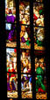 Story of saints in stained-glass of Duomo. Milan, Italy.