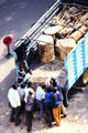 Loading tree trunk by hand onto truck in Nairobi. Kenya.