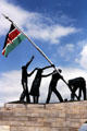Figures raising Kenyan flag part of Uhuru Monument near Nairobi. Kenya.
