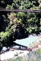 Spectators look on as people bungy jump from Kawarau suspension bridge. New Zealand.