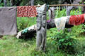 Carved post supports a pole full of laundry in Timbunke. Papua New Guinea.