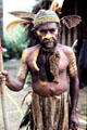 Chimbu warrior wearing war paint and typical dress. Papua New Guinea.