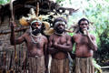 Three warriors in a Chimbu village. Papua New Guinea.