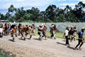 Armed with spears villagers run down road to combat. Papua New Guinea.