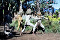 Archers with huge mud masks perform in the Mudmen village. Papua New Guinea.