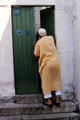 Man entering door in Medina. Tunis, Tunisia.