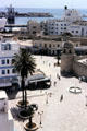 Rue Al Madina Almounawara pedestrian street with corner tower of Great Mosque & port beyond. Sousse, Tunisia.