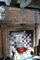 Fireplace with carved surround & painted ceramic tiles in Oak room at John Knox House. Edinburgh, Scotland.