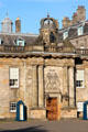 Holyrood Palace wing built under Charles II with crowned clock tower over doorway. Edinburgh, Scotland