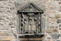 Carved plaque with angels on heritage building near Canongate on Royal Mile. Edinburgh, Scotland.