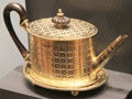 Silver gilt tea pot with heraldic symbols from London at National Museum of Scotland. Edinburgh, Scotland.
