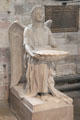 Carved angel holding baptismal shell font at St Giles Cathedral. Edinburgh, Scotland.