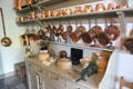Array of copper pans & molds plus ceramic vessels in kitchen at Georgian House museum. Edinburgh, Scotland.