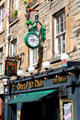 Wall clock with drinking toucan over Dirty Dicks pub on159 Rose Street. Edinburgh, Scotland