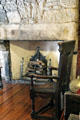 Scottish oak great chair before fireplace with iron grate at Provand's Lordship. Glasgow, Scotland.