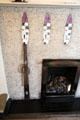 Steel fireplace grasping tool by C.R. Mackintosh on drawing room fireplace at Hill House. Helensburgh, Scotland.