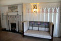 Arrangement of fireplace, wall panels & settle in drawing room at Hill House. Helensburgh, Scotland.