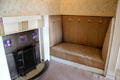 Fireplace with tile squares & built-in settle with thistle motif in main bedroom at Hill House. Helensburgh, Scotland.