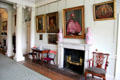 Hallway fireplace, furniture & paintings at Pollok House. Glasgow, Scotland.