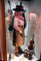 Outfit of woman farm worker plus fiddle & squeeze box at National Museum of Rural Life. Kittochside, Scotland.