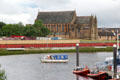 Govan Ferry on River Clyde from Kelvin Harbour with Govan Old Parish Church beyond. Glasgow, Scotland.