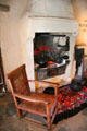 Living area with fireplace & oak chair at Robert Burns Cottage. Alloway, Scotland.