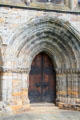 Gothic processional entrance arch with 19th C doors at Dunblane Cathedral. Dunblane, Scotland.