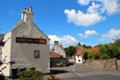 Low Causeway streetscape with Red Lion & Culross Town House tower beyond. Culross, Scotland.
